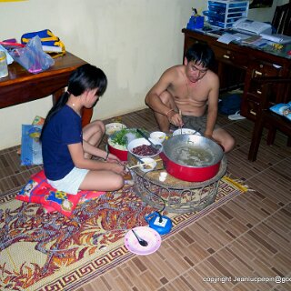 DSCN0504 guest house caretakers prepare food in the hallway